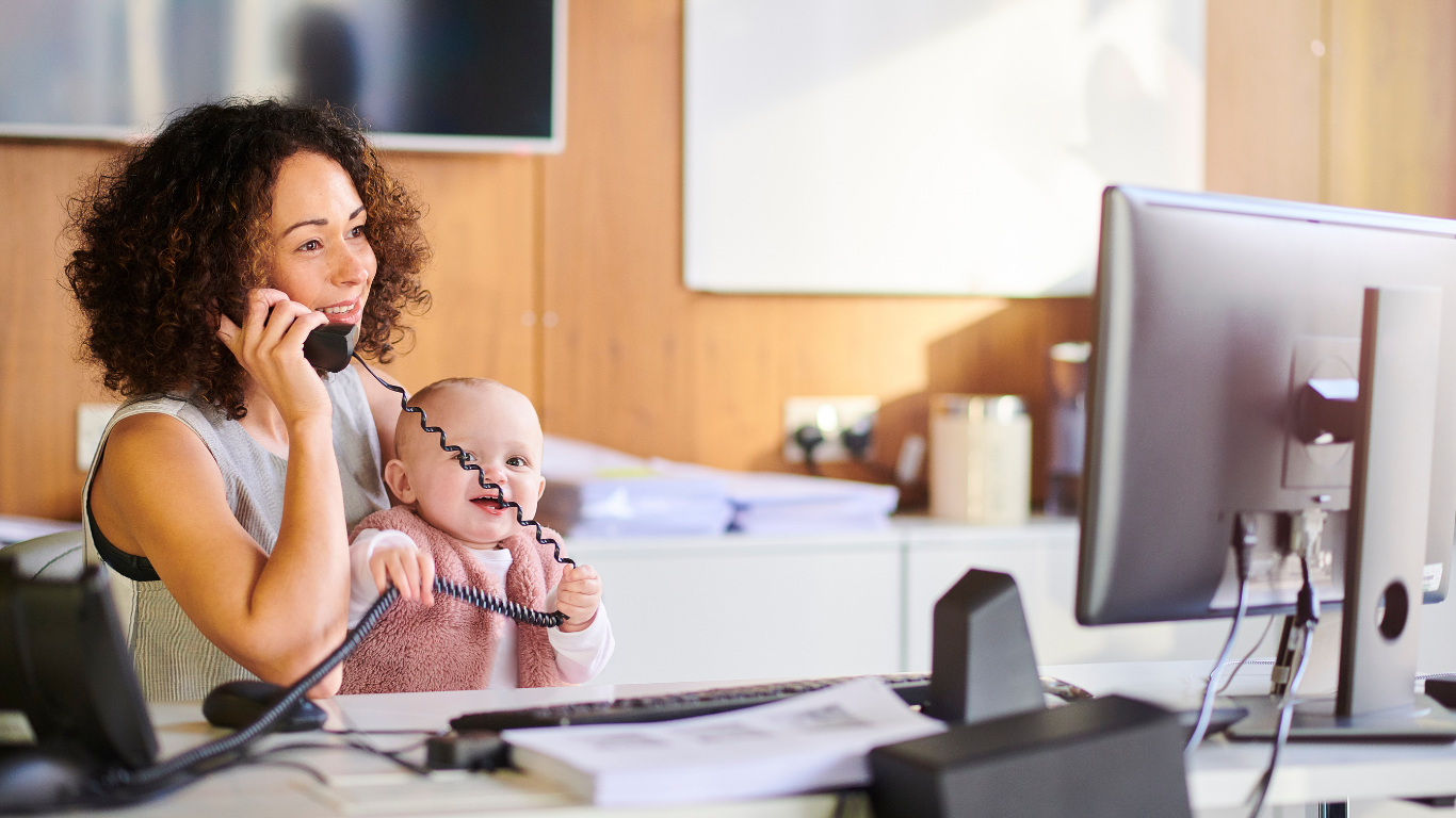 working mum holding baby