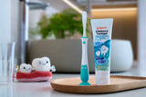 Training toothbrush step 4 mint with childrens toothgel natural flavour on bathroom counter.