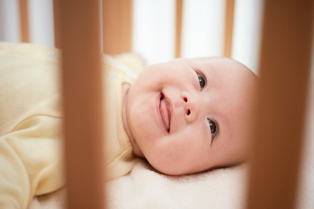 baby smiling in cot