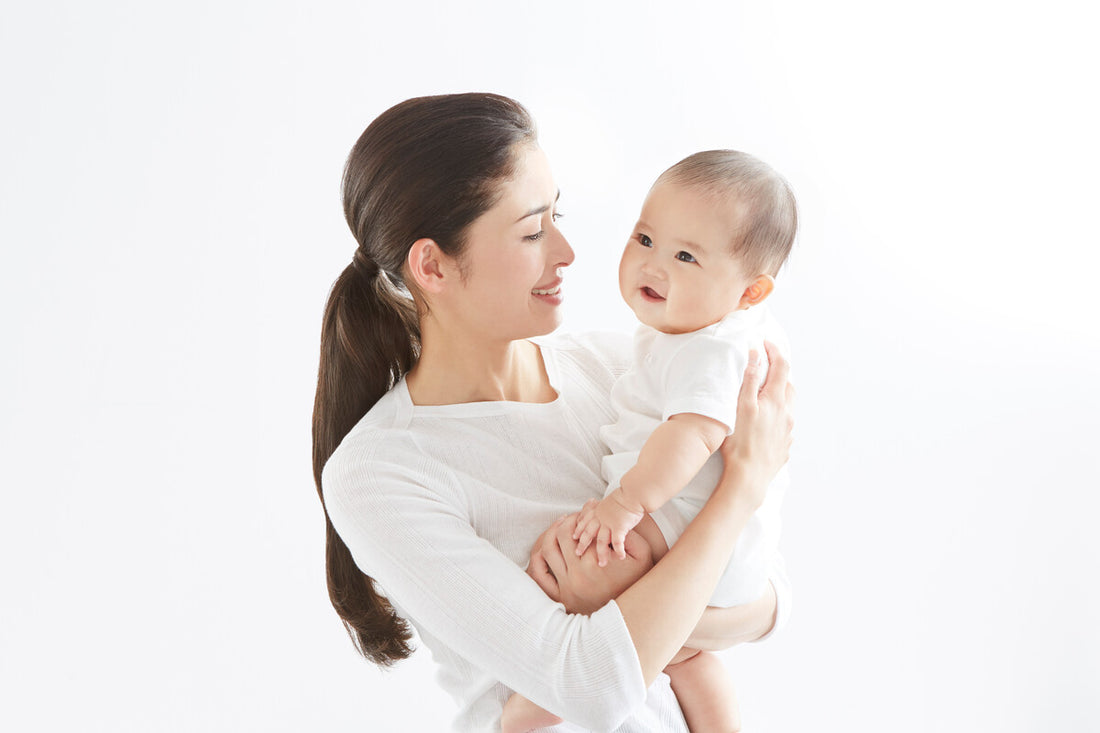 mother holding baby upright to help soothe reflux