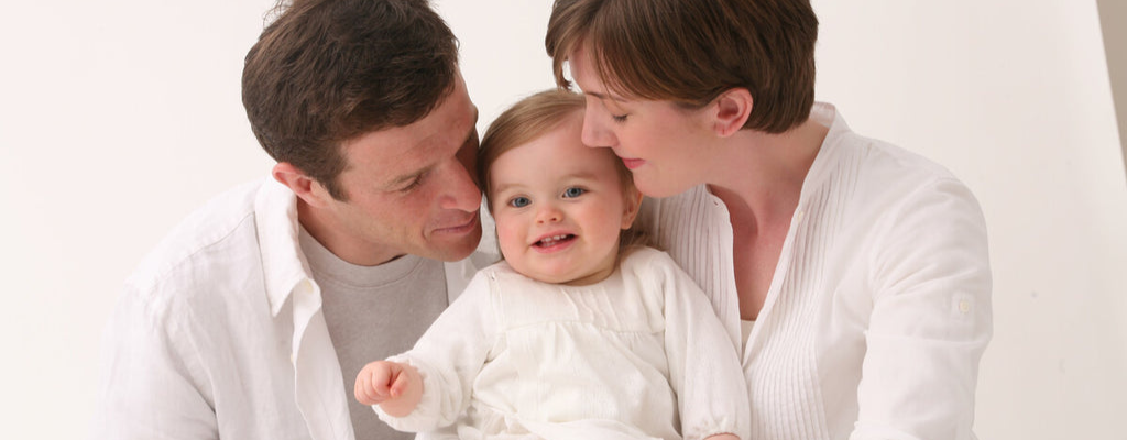 parents holding baby
