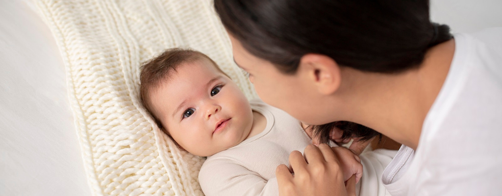 baby on blanket with parent