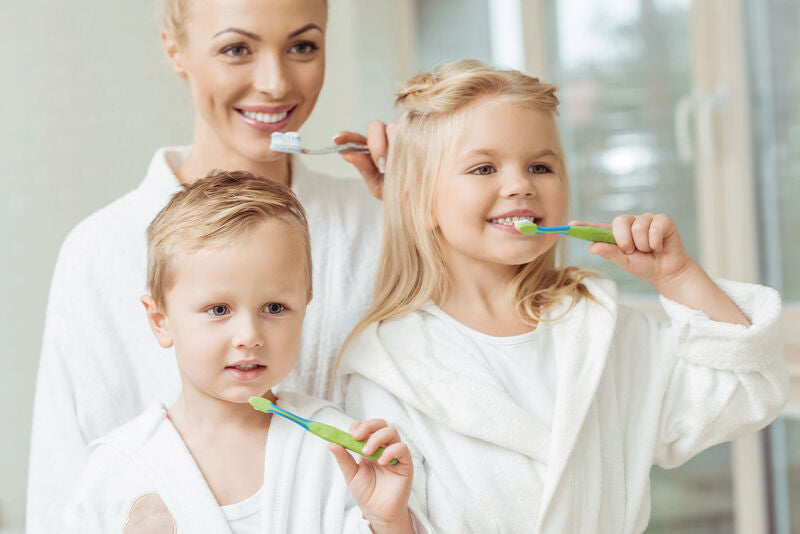 family brushing teeth