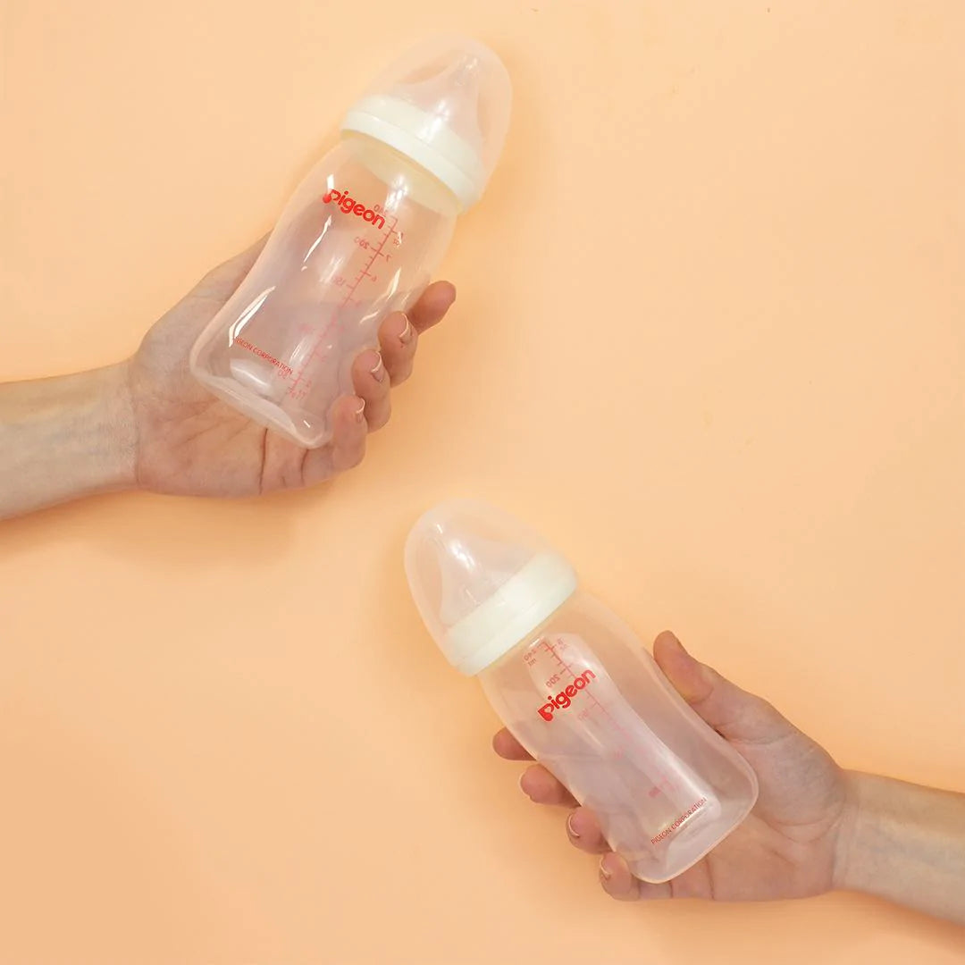 reflux baby bottles with peach background