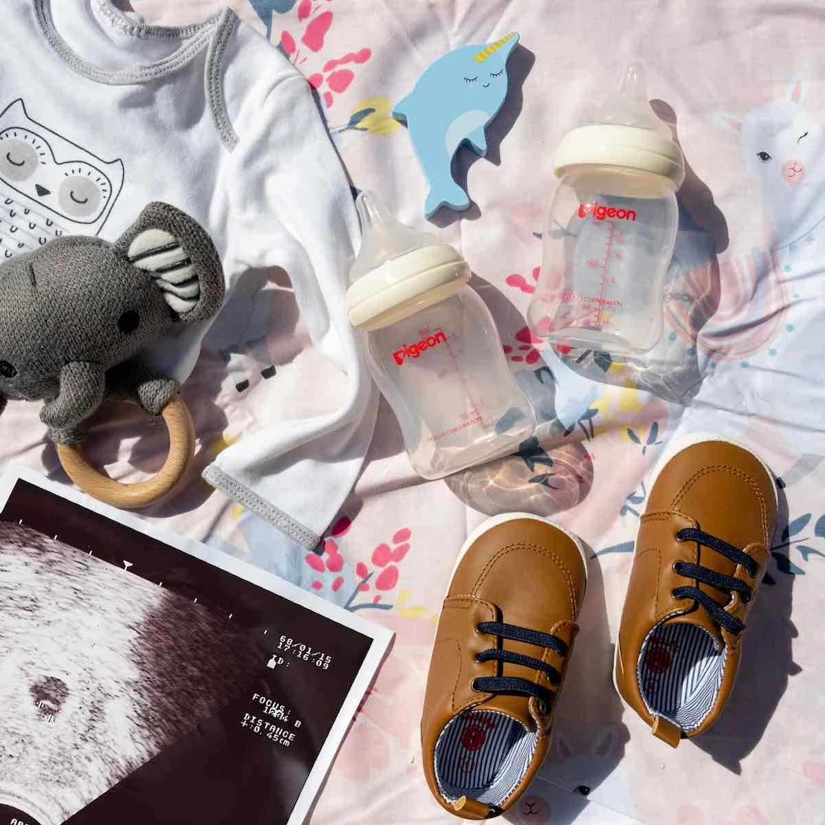 newborn bottle, shoes and rattle
