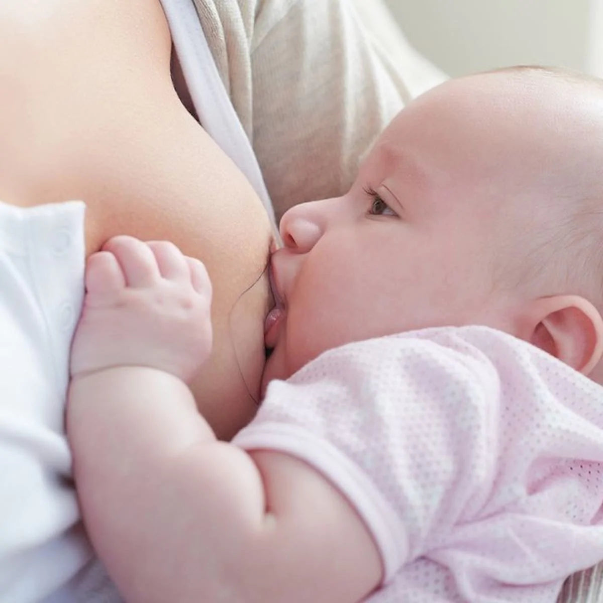 mother wearing a nipple shield whilst feeding baby
