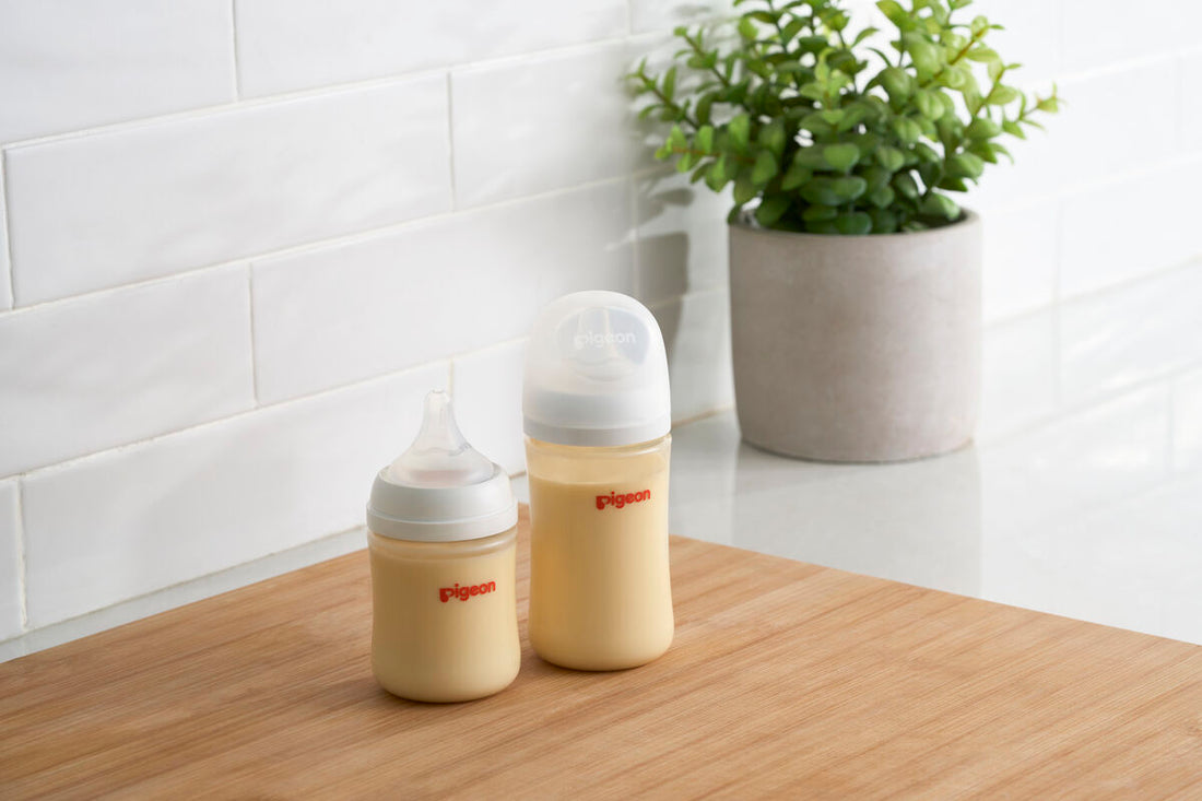 Baby bottles with a plant in the background