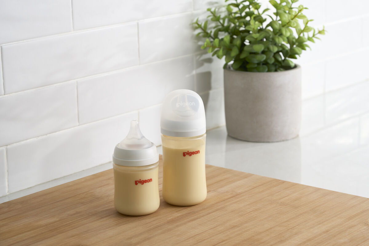 Baby bottles with a plant in the background