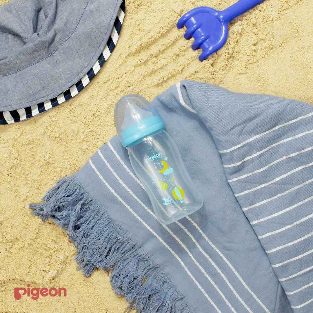 large baby bottle at the beach