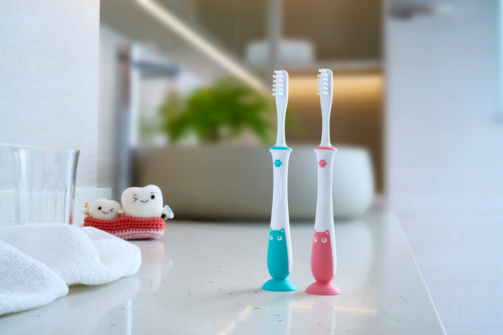 Pigeon baby training toothbrush step 4 pink pictured on a bathroom counter