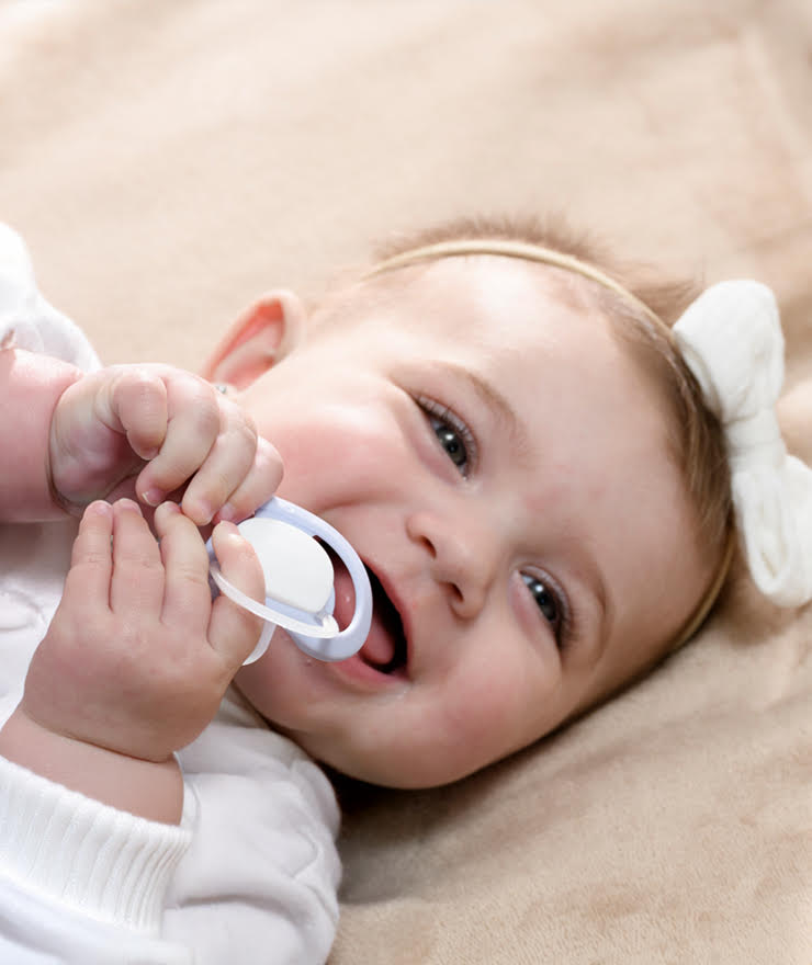 baby holding dummy