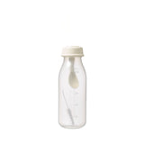 a 240mL pigeon weaning bottle with spoon in the bottle